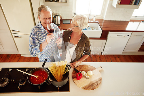 Image of Top view, wine or old couple cooking food for a healthy vegan diet together with love in retirement at home. Happy senior woman drinking or bonding in house kitchen with mature husband at dinner