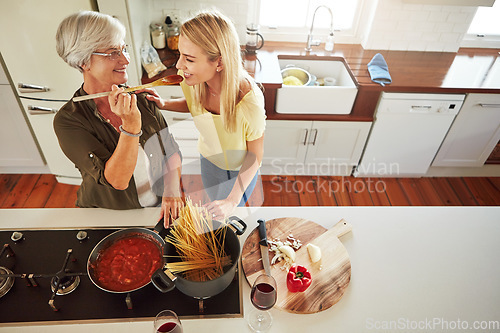 Image of Taste, woman or mother cooking food for a healthy vegan diet together with love in family home. Smile, tasting or adult child learning or helping senior mom in house kitchen for lunch meal or dinner