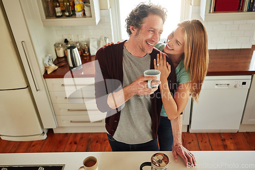 Image of Hugging, tea or happy couple laughing in kitchen at home bonding or enjoying quality time together. Embrace, affection or above of funny mature man relaxing or drinking coffee with woman at home