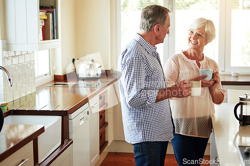 Image of Chat, coffee or old couple talking in a kitchen at home bonding or enjoying quality time together. Happy, retirement or mature man in conversation, relaxing or drinking tea espresso with senior woman