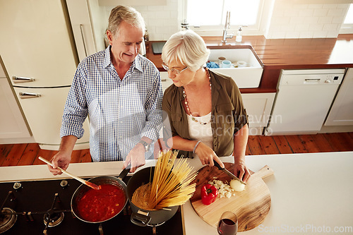 Image of Top view, happy or old couple kitchen cooking with healthy food for lunch or dinner together at home. Love, help or senior woman smiling or talking to mature husband in meal preparation in retirement