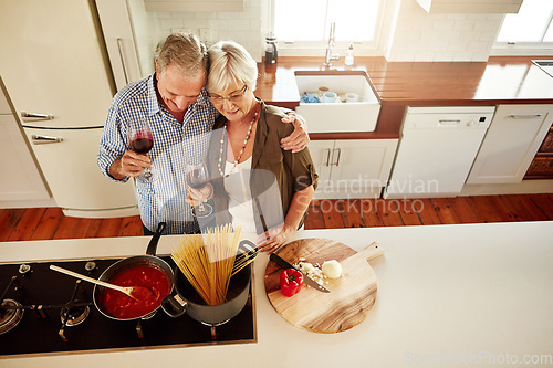 Image of Hugging, wine or old couple cooking food for a healthy vegan diet together with love in retirement at home. Top view of senior woman drinking or bonding in house kitchen with mature husband at dinner