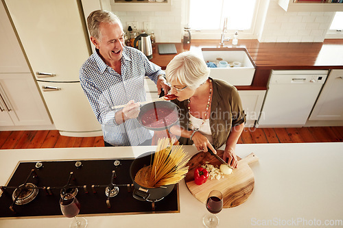 Image of Top view, tasting or old couple kitchen cooking with healthy food for lunch or dinner together at home. Love, taste or senior woman helping or eating with mature man in meal preparation in retirement