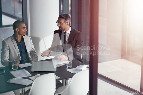 Image of Advice, tablet and business man with partner at meeting, conference room and window reflection in financial planning. Professional people or accountant on digital tech, talking finance and accounting