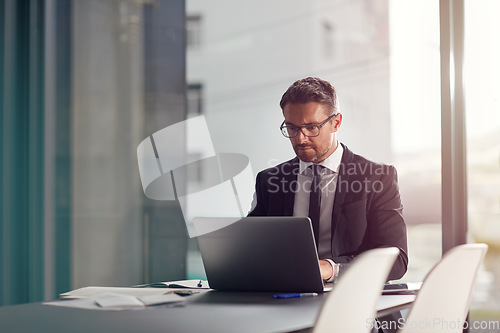 Image of Business man, corporate office and laptop in online management, career planning and company software. Serious, focus and professional person or worker in conference room typing on computer or website