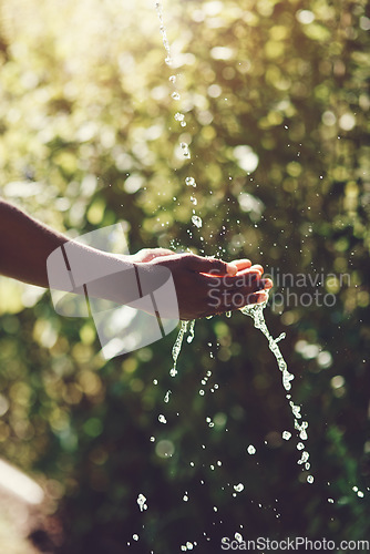 Image of Water, splash and hydration with a person washing hands outdoor in nature for life, sustainability or moisture. Environment, stream and wet with an adult cleaning outside for wellness or hygiene