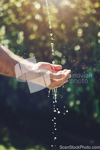 Image of Water, wellness and hydration with a person washing hands outdoor in nature for life, sustainability or moisture. Environment, splash and wet with an adult cleaning outside for wellness or hygiene