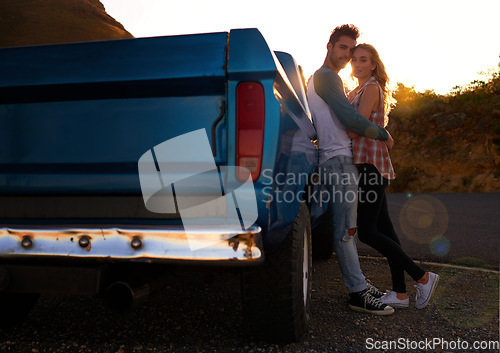 Image of Couple, portrait and sunset by pickup truck for road trip with love, romance or date on adventure, travel or journey. Man, woman and hug for care, mockup and transportation for outdoor in countryside