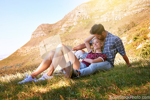 Image of Relax, kiss and happy with couple in nature for carefree, bonding and affectionate. Happiness, date and romance with man and woman cuddle in grass field for summer break, love and mountains