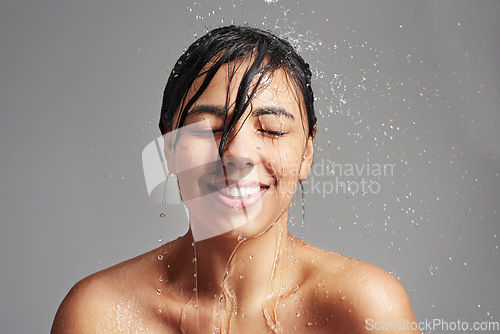 Image of Cleaning, shower and face of woman with water in studio on gray background for wellness, beauty and grooming. Skincare, bathroom and happy female person for washing hair, facial care and cleansing