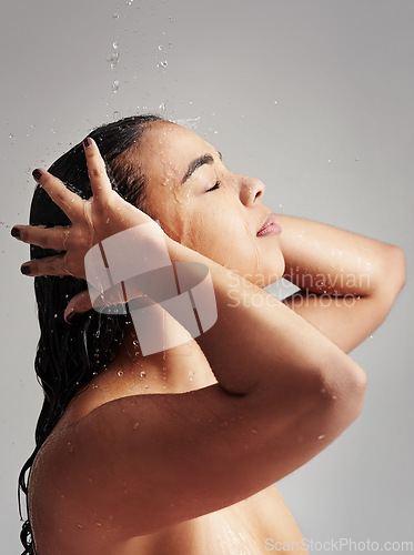 Image of Shower, washing hair and profile of woman with water in studio for wellness, cleaning and grooming. Beauty, bathroom and face of female person for hygiene, body care and cleansing on gray background