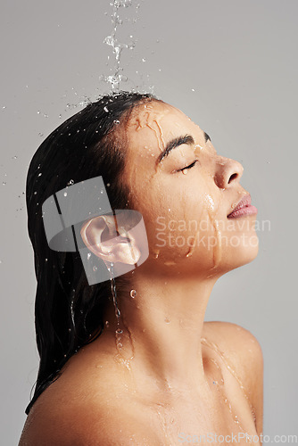 Image of Shower, washing and face of woman with water in studio on grey background for wellness, cleaning and grooming. Hair care, bathroom and female person with beauty for hygiene, satisfaction and health