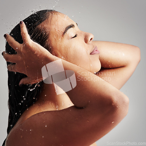 Image of Shower, washing hair and face of woman with water in studio for wellness, cleaning and grooming. Beauty, bathroom and profile of female person for hygiene, self care and cleansing on gray background