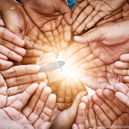 Image of Closeup, hands and teamwork with collaboration, partnership and charity with sun flare. Group, people or volunteers with sunshine, friends and goals with help, hope and community with support or palm