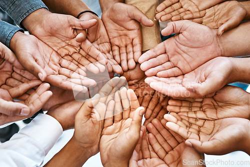 Image of Hands, palm and diversity of people in circle of charity, support and community together from above. Closeup, helping hand and teamwork for crowdfunding, donation and society of peace, unity and care