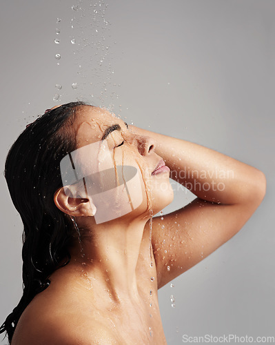 Image of Water splash, shower and face of woman in studio on gray background for wellness, cleaning and grooming. Skincare, beauty mockup and profile of female person for washing hair, self care and cleansing