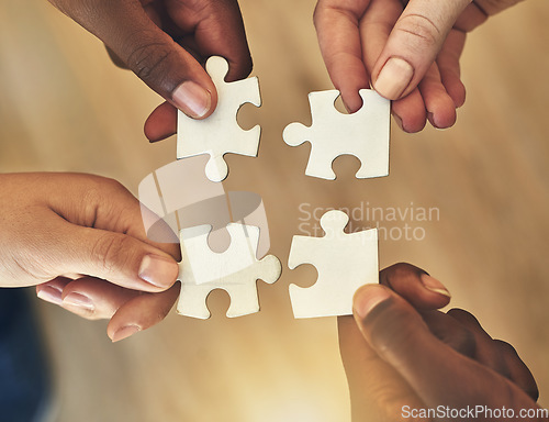 Image of Team, hands and puzzle for teamwork and collaboration of business people for challenge or project. Above group of men and women working together on mockup jigsaw for solution, synergy or goal