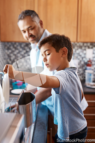 Image of Home, father and son washing dishes, family and help with development, cleaning and chores. Male parent, dad and son in the kitchen, teaching skills and growth with bonding, learning and cooperation