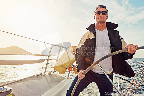 Image of Water adventure, rich man sailing on a yacht and retirement on sea with in blue sky. Travel or freedom, sunshine or relax and mature male on summer vacation or holiday break on cruise boat.