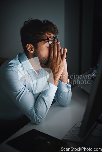 Image of Stress, night and a businessman with a headache at work, deadline burnout and frustrated. Sad, problem and a corporate employee in a dark office with anxiety or depression from an email on a pc