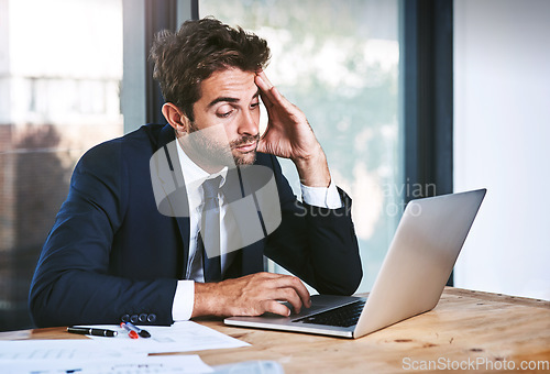 Image of Tired, laptop and stress businessman lazy with a headache in an office typing on a computer online or the internet. Sleepy, burnout and depressed male corporate person writing a report or research