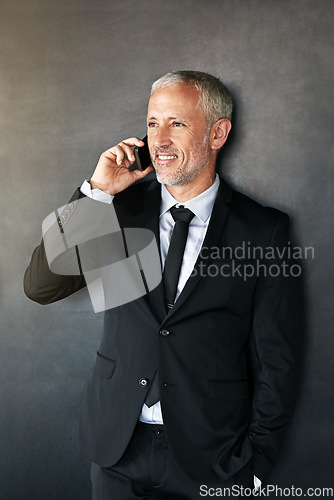 Image of Happy businessman, phone call and thinking with communication, contact and network in studio. A senior entrepreneur person on a grey background with a smartphone for conversation and connection