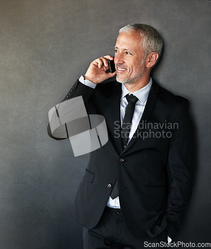 Image of Thinking, happy and businessman on a phone call for communication, contact and network in studio. Senior entrepreneur person on grey background with a smartphone for conversation, mockup or idea