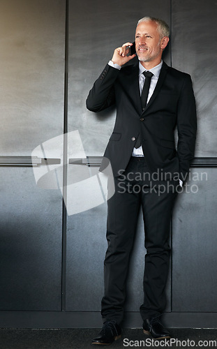 Image of Phone call, businessman and happy for communication, contact and network in office. A senior entrepreneur person on a grey wall with a cellphone for conversation and thinking about corporate idea