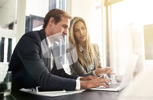 Image of Business man, woman or partner on laptop and pointing, typing or help with question, talking or workplace. Businessman, female manager and computer for corporate training, teamwork or solution at job