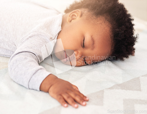 Image of Baby, african boy and sleep in bedroom for rest, health and peace for growth, development and relax in family home. Black male infant, tired and sleeping on bed with fatigue, quiet and calm in house