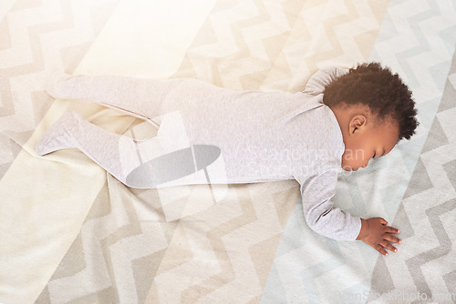 Image of Top view, bedroom and baby sleeping in home for rest, nap time and dreaming in nursery blanket. Childcare, newborn and above of cute, tired and African child in bed sleep for comfort, relax and calm