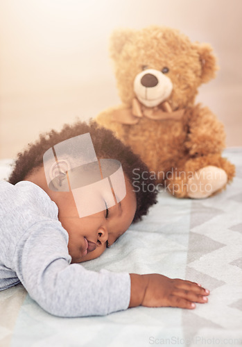 Image of Sleeping, teddy bear and dreaming with baby in bedroom for carefree, development and innocence. Cute, relax and comfortable with african infant and toy resting at home for morning, nap and bedtime