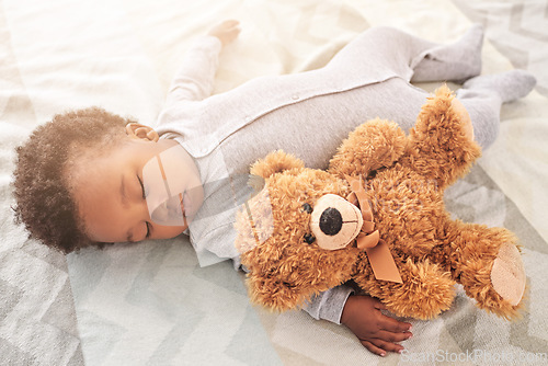 Image of Sleeping, teddy bear and toy with baby in bedroom for carefree, development and innocence. Dreaming, relax and comfortable with african infant in nursery at home for morning, resting and bedtime