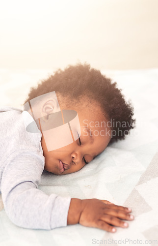 Image of Cute, bed and baby sleeping in home on blanket for rest, nap time and dreaming in nursery. Childcare, newborn and adorable, tired and African child in bedroom sleep for comfort, relaxing and calm