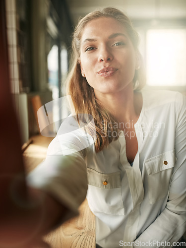 Image of Selfie, woman and kiss pose at cafe, coffee shop or restaurant and happy, lips and portrait of morning routine. Female person, face and pout or flirt, photograph for social media or profile picture