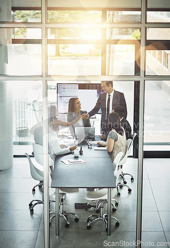 Image of Business meeting, partnership and b2b handshake in office for partnership, trust and startup deal. Businessman, shaking hands and team in a boardroom for synergy, integration and thank you gesture