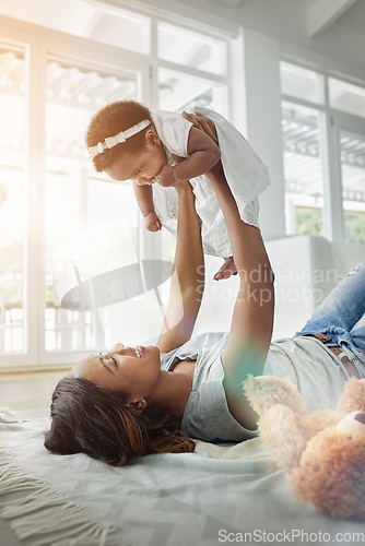 Image of Happy black woman, baby and playing on floor with love, teddy bear and smile together in living room. Happiness, mother and daughter in flying bonding, quality time for parent and newborn in home.