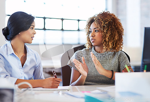 Image of Teamwork, meeting and planning with business women in the office, talking about company strategy. Collaboration, partnership and communication with a female employee chatting to a colleague at work