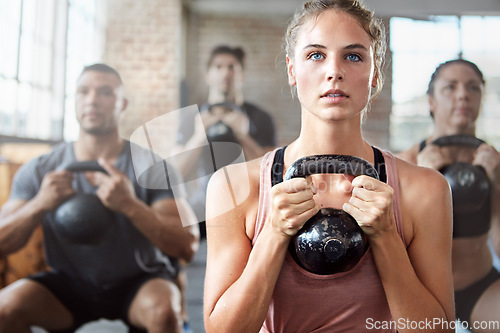 Image of Fitness, exercise and woman with kettlebell in a gym for a strength training challenge. Sports, energy and female athlete doing a workout with weights with her friends or community in wellness center