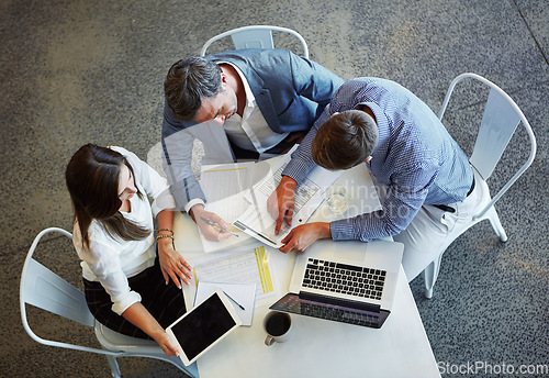 Image of Top view, business and employees planning, documents and discussion for review, feedback or partnership. Staff, group or coworkers check paperwork, conversation or collaboration with ideas or talking