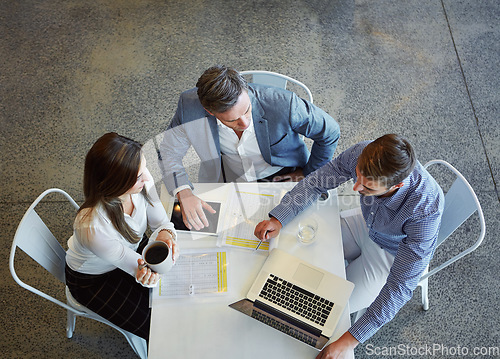 Image of Top view, business and employees with planning, teamwork and collaboration in the workplace. Staff, group and coworkers with a laptop, brainstorming and share ideas with conversation and development