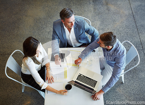 Image of Top view, staff and group planning, brainstorming and conversation for growth, development and teamwork. Employees, coworkers and business people share ideas, laptop and discussion with collaboration