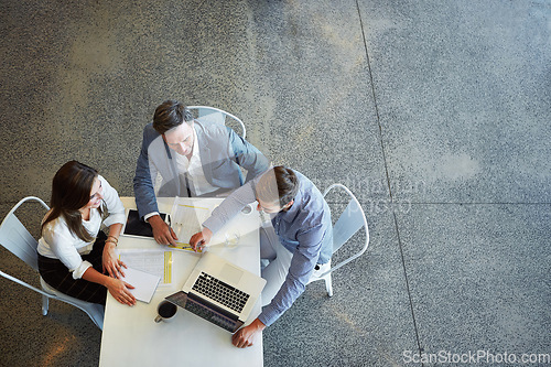 Image of Top view, business and team planning, technology and teamwork in the workplace, collaboration and brainstorming. Group, coworkers and employees share ideas, laptop and meeting for a new project