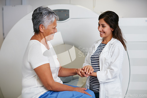 Image of Doctor, ct scan and woman holding hands of patient in hospital before scanning in machine. Mri, comfort and happy medical professional with senior female person before radiology test for healthcare.