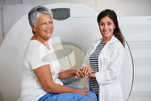 Image of Portrait of doctor, mri and woman with patient in hospital before scanning in machine. Ct scan, holding hands and happy medical professional comfort senior person before radiology test for healthcare