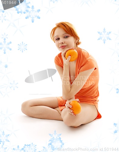 Image of cheerful redhead with two oranges