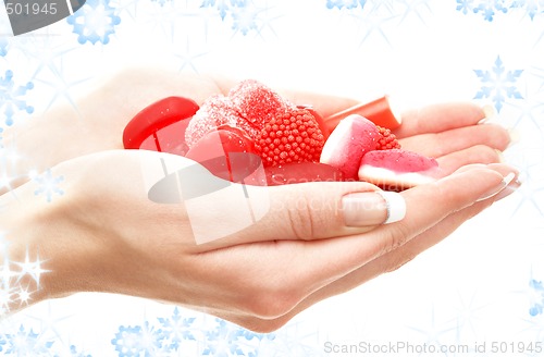 Image of hands full of red bonbons