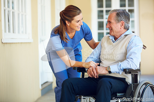 Image of Speaking, happy caregiver or old man in wheelchair in hospital helping an elderly patient for support in clinic. Medical nurse or healthcare social worker talking to a senior person with disability