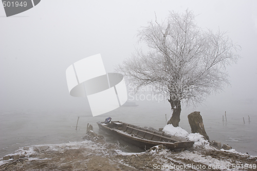 Image of traditional fishing boats on river Danube mid winter