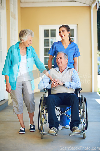 Image of Wife, caregiver laughing or old man in wheelchair in hospital clinic helping an elderly patient for support. Funny, happy or healthcare nurse speaking or smiling with senior people with a disability
